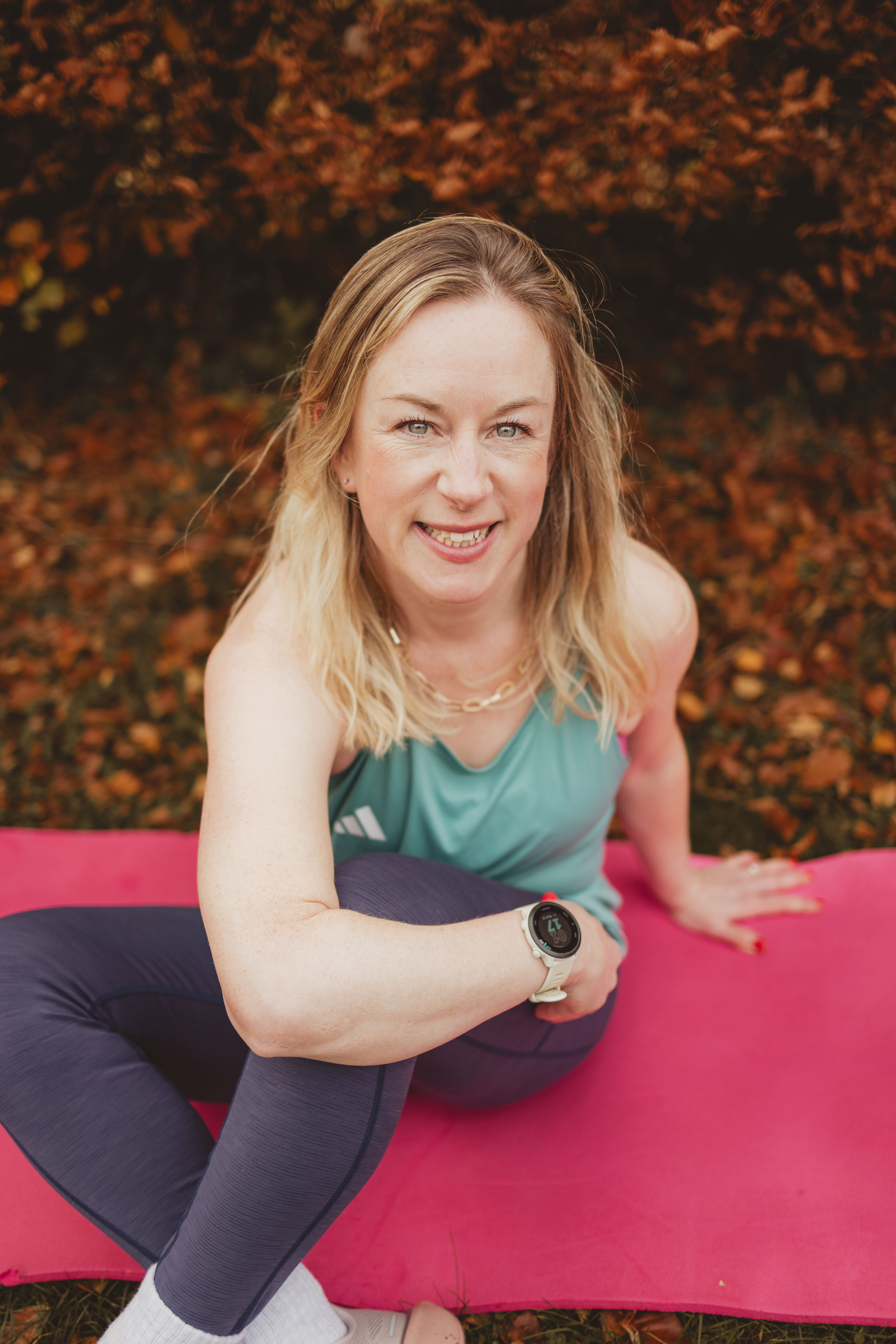 Dr Kate Ella on a yoga mat outdoors